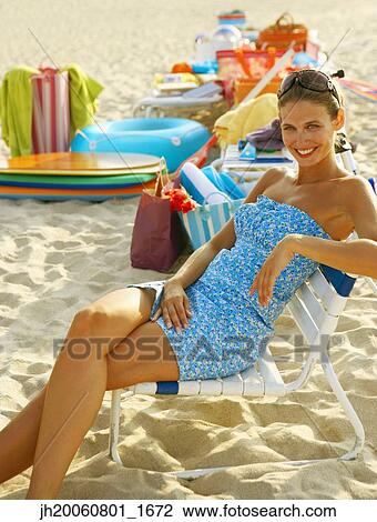 Young women sitting in beach chair View Large Photo Image Stock Image - Young women sitting in beach chair. Fotosearch