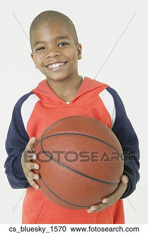 African boy holding basketball View Large Photo Image Stock Image - African boy holding basketball. Fotosearch