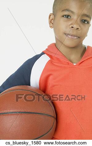 African boy holding basketball View Large Photo Image Stock Image - African boy holding basketball. Fotosearch