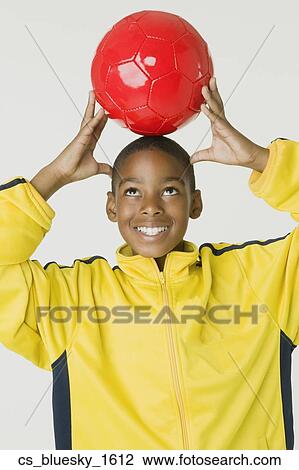 African boy holding soccer ball View Large Photo Image Stock Image - African boy holding soccer ball. Fotosearch