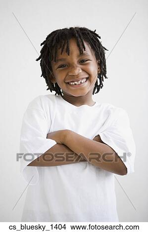 Picture - African boy with arms crossed. Fotosearch