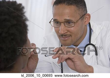African doctor examining patient View Large Photo Image Stock Image - African doctor examining patient. Fotosearch