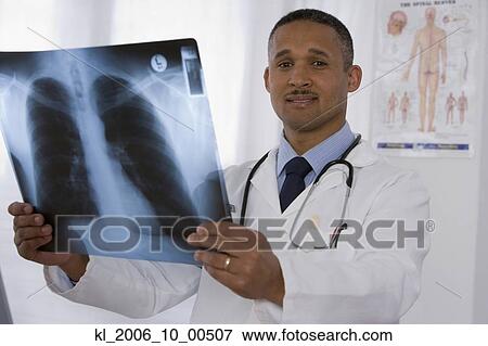 Stock Photo - African doctor holding x-ray. Fotosearch
