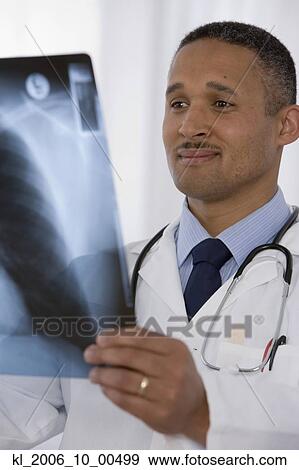 Stock Photo - African doctor looking at x-ray. Fotosearch