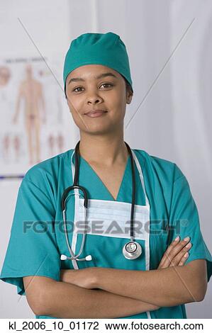 Stock Image - African female doctor with arms crossed. Fotosearch