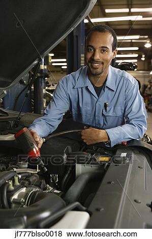 Stock Photo - African male auto mechanic in shop. Fotosearch