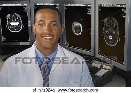 African male doctor smiling in front of brain scans View Large Photo Image Stock Photography - African male doctor smiling in front of brain scans. Fotosearch