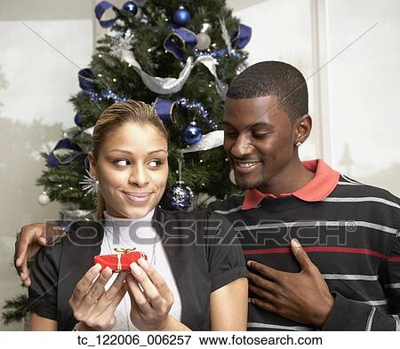 African man giving gift to girlfriend View Large Photo Image Stock Photo - African man giving gift to girlfriend. Fotosearch