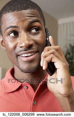 Stock Photo - African man talking on cell phone. Fotosearch