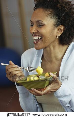 African woman eating fruit View Large Photo Image Stock Photo - African woman eating fruit. Fotosearch
