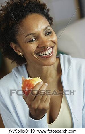 African woman eating fruit View Large Photo Image Stock Photo - African woman eating fruit. Fotosearch
