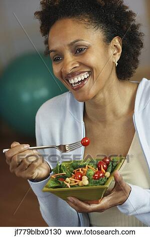 African woman eating salad View Large Photo Image Stock Image - African woman eating salad. Fotosearch