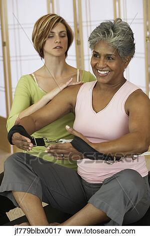 African woman exercising with personal trainer View Large Photo Image Stock Photo - African woman exercising with personal trainer. Fotosearch