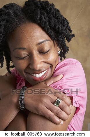African woman hugging self View Large Photo Image Stock Image - African woman hugging self. Fotosearch