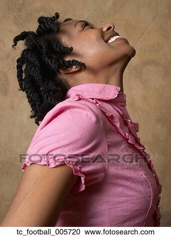Stock Image - African woman looking up. Fotosearch