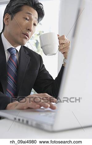 Asian businessman typing on laptop View Large Photo Image Stock Image - Asian businessman typing on laptop. Fotosearch