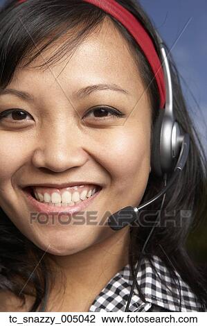 Asian businesswoman wearing headset View Large Photo Image Stock Image - Asian businesswoman wearing headset. Fotosearch