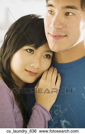 Stock Photograph - Asian couple hugging. Fotosearch