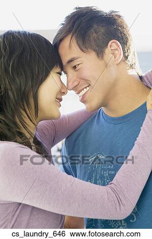 Stock Photograph - Asian couple hugging. Fotosearch