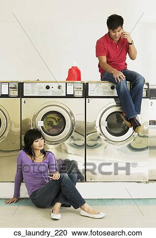 Asian couple in Laundromat View Large Photo Image Stock Image - Asian couple in Laundromat. Fotosearch