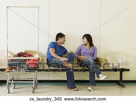 Asian couple in laundromat View Large Photo Image Stock Image - Asian couple in laundromat. Fotosearch