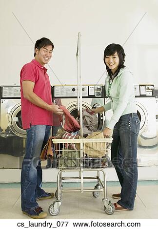 Asian couple in laundromat View Large Photo Image Stock Photo - Asian couple in laundromat. Fotosearch