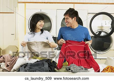 Stock Photo - Asian couple in Laundromat. Fotosearch