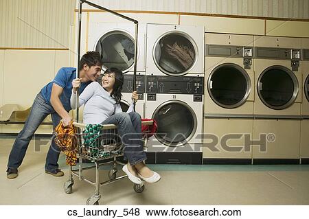 Stock Photo - Asian couple in Laundromat. Fotosearch