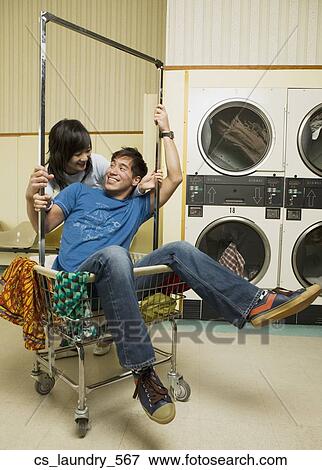 Stock Photo - Asian couple in Laundromat. Fotosearch