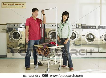 Stock Photograph - Asian couple in laundromat. Fotosearch