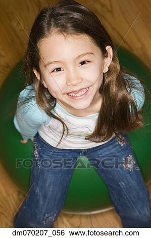 Asian girl sitting on ball View Large Photo Image Stock Photograph - Asian girl sitting on ball. Fotosearch