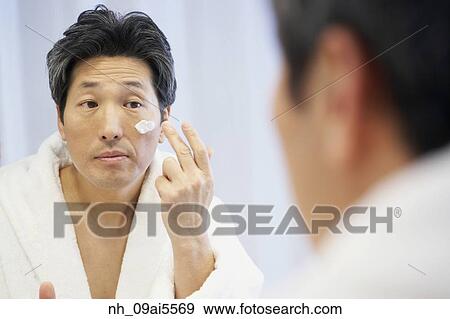 Asian man applying face cream View Large Photo Image Stock Photo - Asian man applying face cream. Fotosearch