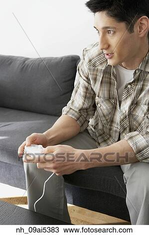 Asian man playing video games View Large Photo Image Stock Image - Asian man playing video games. Fotosearch