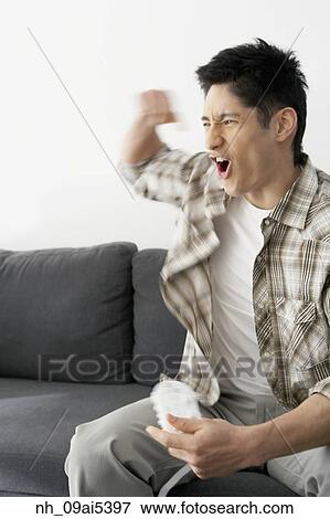 Asian man playing video games View Large Photo Image Stock Photo - Asian man playing video games. Fotosearch