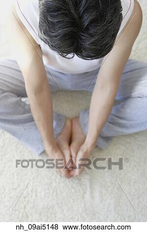 Stock Photo - Asian man practicing yoga. Fotosearch