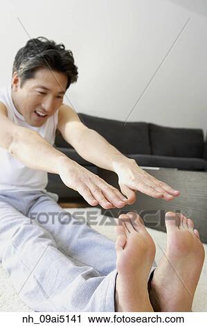 Asian man trying to touch toes View Large Photo Image Stock Image - Asian man trying to touch toes. Fotosearch
