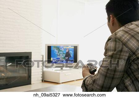 Asian man watching television View Large Photo Image Stock Photo - Asian man watching television. Fotosearch