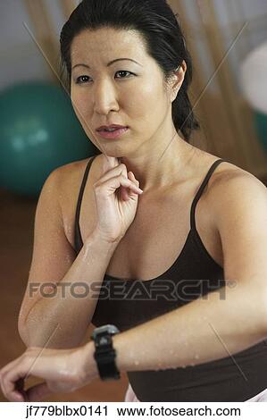 Asian woman checking pulse View Large Photo Image Stock Image - Asian woman checking pulse. Fotosearch