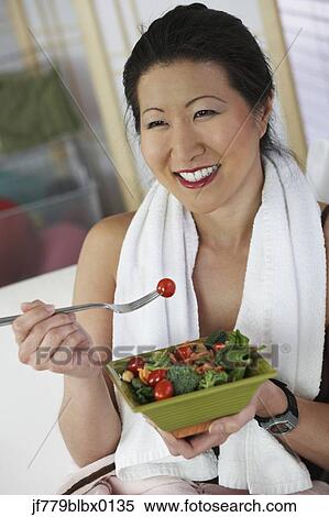 Asian woman eating salad View Large Photo Image Stock Photography - Asian woman eating salad. Fotosearch