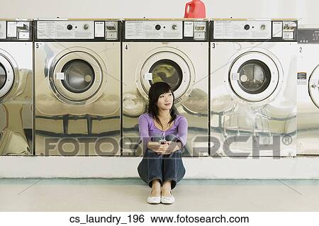 Asian woman in laundromat View Large Photo Image Stock Photograph - Asian woman in laundromat. Fotosearch
