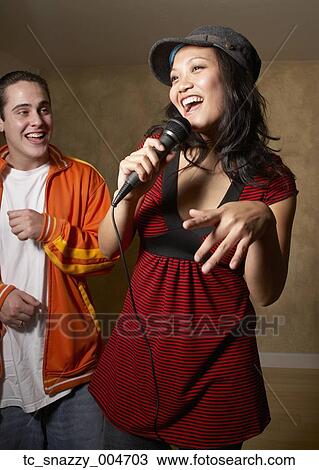 Asian woman singing with microphone View Large Photo Image Stock Image - Asian woman singing with microphone. Fotosearch