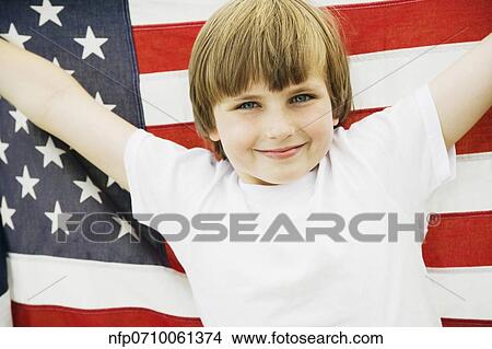 Boy holding up American flag View Large Photo Image Picture - Boy holding up American flag. Fotosearch