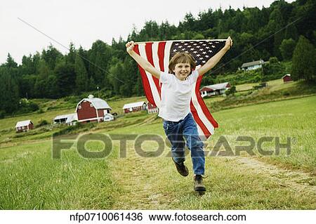Boy running with American flag at farm View Large Photo Image Stock Photograph - Boy running with American flag at farm. Fotosearch