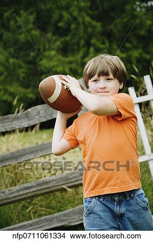 Boy throwing football View Large Photo Image Picture - Boy throwing football. Fotosearch
