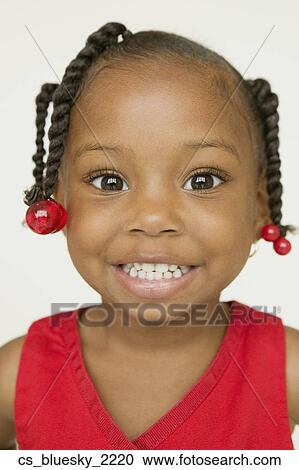 Stock Image - Close up of African girl smiling. Fotosearch