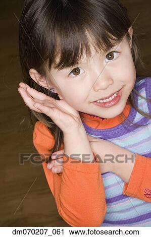 Stock Image - Close up of Asian girl smiling. Fotosearch