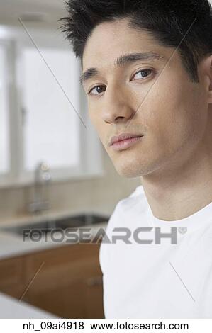 Close up of Asian man in kitchen View Large Photo Image Stock Photo - Close up of Asian man in kitchen. Fotosearch