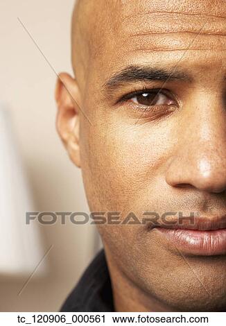 Stock Image - Close up of Mixed Race man’s face. Fotosearch