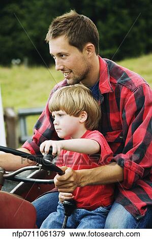 Father and on driving tractor View Large Photo Image Stock Photo - Father and on driving tractor. Fotosearch