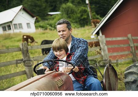 Father and son driving tractor View Large Photo Image Stock Photograph - Father and son driving tractor. Fotosearch